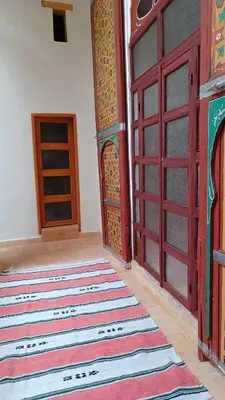 a room with a door and a rug on the floor at Dar Ayoub in Fès