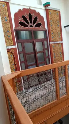 a wooden door with a window on a building at Dar Ayoub in Fès