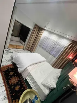 a small bed in a room with a window at Escape Villa City center pool 3 bedrooms in Oulad Akkou