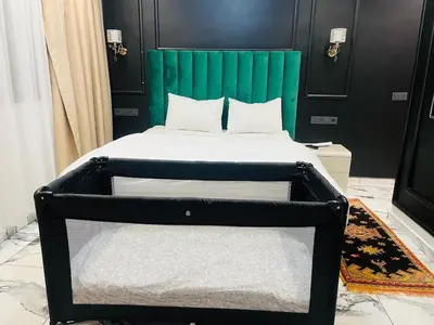 a bed with a green headboard in a room at Escape Villa City center pool 3 bedrooms in Oulad Akkou