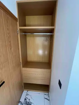 a closet with a wooden cabinet in a room at Escape Villa City center pool 3 bedrooms in Oulad Akkou