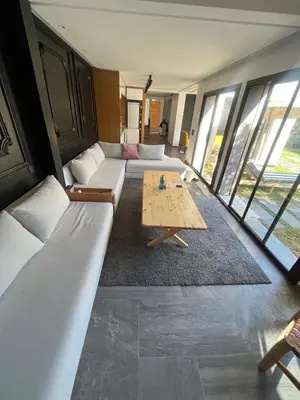 a living room with couches and a coffee table at Escape Villa City center pool 3 bedrooms in Oulad Akkou