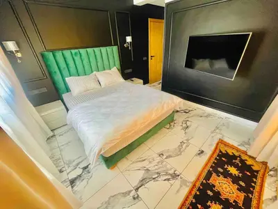 a bedroom with a bed with a marble floor at Escape Villa City center pool 3 bedrooms in Oulad Akkou