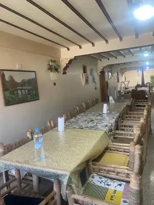 a long table with a bottle of water on top of it at Maison d'hôtes Moussem des fiançailles in Imilchil