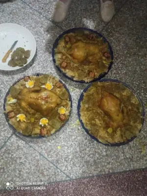three plates of food on the floor with food in them at Maison d'hôtes Moussem des fiançailles in Imilchil