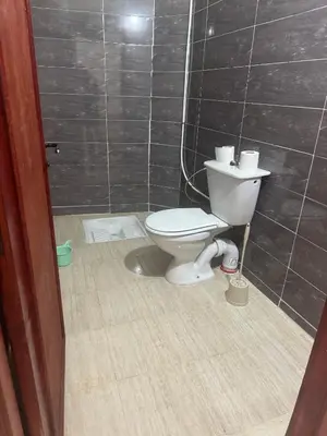 a bathroom with a toilet in a tiled room at Hostel dallas Warzazate in Ouarzazate