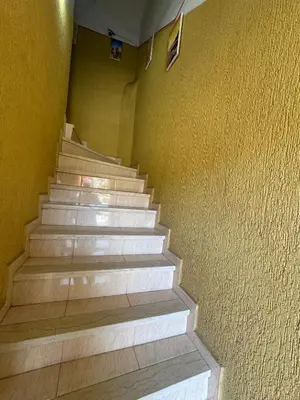 a set of stairs in a room with yellow walls at Hostel dallas Warzazate in Ouarzazate