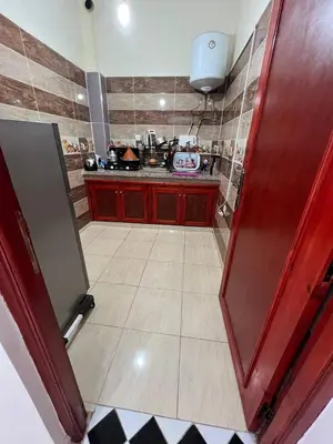 a kitchen with a red door and a counter top at Hostel dallas Warzazate in Ouarzazate