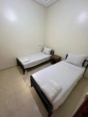 two twin beds in a room with at Hostel dallas Warzazate in Ouarzazate