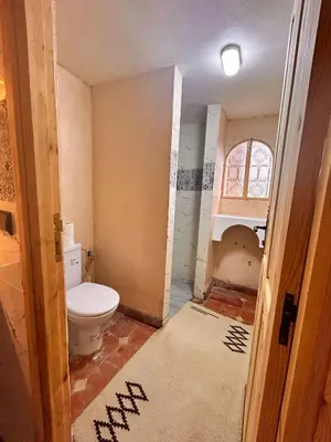 a bathroom with a toilet in a room at Serenity Lodge Zagora Guest House Restaurant & Desert Excursions in Zagora