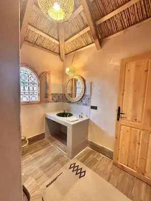 a bathroom with a sink and a mirror at Serenity Lodge Zagora Guest House Restaurant & Desert Excursions in Zagora