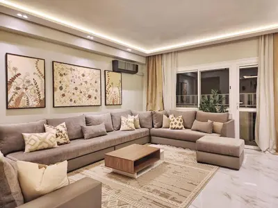 a living room with a couch and a table at appartement de luxe réservée aux familles in Meknès