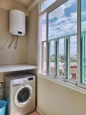 a washing machine in a laundry room with a window at appartement de luxe réservée aux familles in Meknès