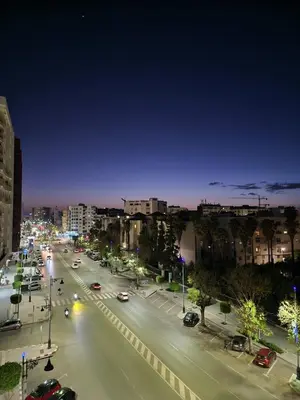 a city street at night with cars on the road at appartement de luxe réservée aux familles in Meknès