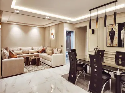 a living room with a couch and a table at appartement de luxe réservée aux familles in Meknès
