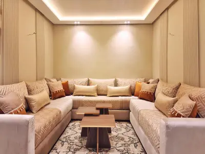 a living room with a large couch and a table at appartement de luxe réservée aux familles in Meknès