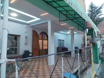 a house being remodeled with a stained glass door at almou auberge Imilichil in Imilchil