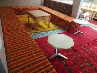 a living room with a couch and a table at almou auberge Imilichil in Imilchil