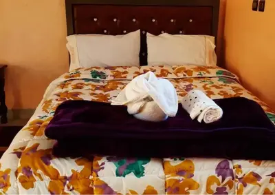 a bed with two towels and two socks on it at Hotel Kasbah Telouet in Telouet