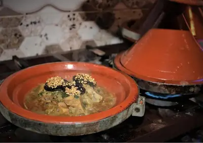 a red bowl of food on a stove at Hotel Kasbah Telouet in Telouet