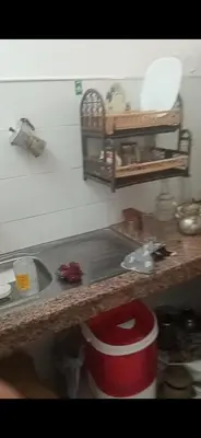 a kitchen counter with a sink and a red bucket at Dar lbahia in Oulad Akkou