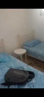 a room with two twin beds and a table at Dar lbahia in Oulad Akkou