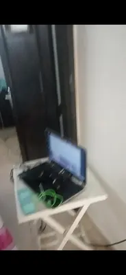 a laptop computer sitting on a white table at Dar lbahia in Oulad Akkou