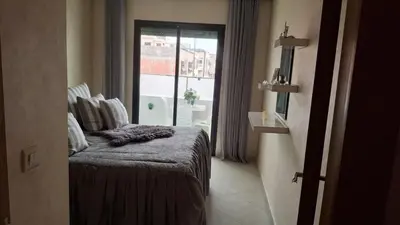 a room with a bed and a window at A new, lively apartment in Oulad Akkou