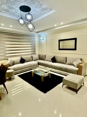 a living room with a couch and a coffee table at charmant appartement in Fès