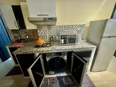 a kitchen with a counter with a microwave and a dishwasher at charmant appartement in Fès
