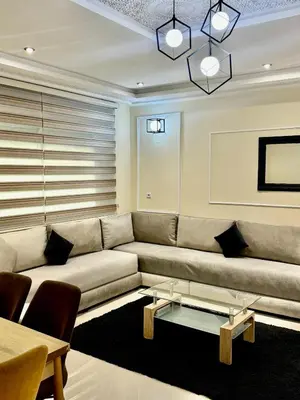 a living room with a couch and a table at charmant appartement in Fès