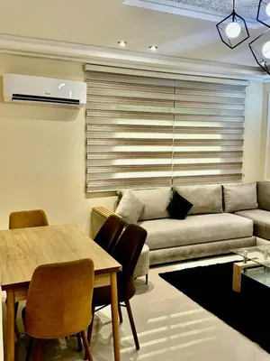a living room with a couch and a table at charmant appartement in Fès