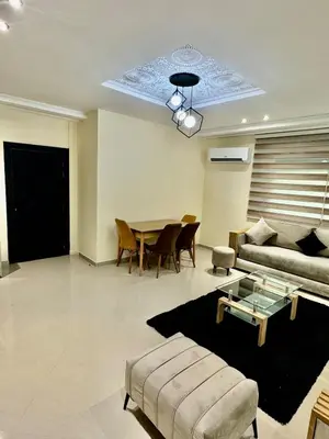 a living room with a couch and a table at charmant appartement in Fès