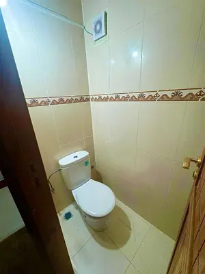a bathroom with a white toilet in a room at apartment champs de cours in Fès