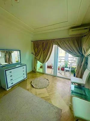 a living room with a dresser and a mirror at apartment champs de cours in Fès