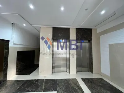 a lobby with a silver elevator in a building at Tanger Apt Near Train & Mall in Oulad Akkou