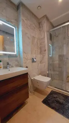 a bathroom with a tub and a sink and a shower at Tanger Apt Near Train & Mall in Oulad Akkou