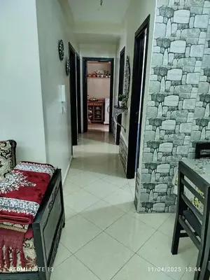 a living room with a stone wall and a bedroom at appartement martil in Oulad Akkou