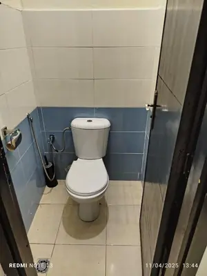 a bathroom with a white toilet in a stall at appartement martil in Oulad Akkou