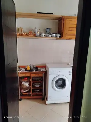 a kitchen with a washing machine in a kitchen at appartement martil in Oulad Akkou