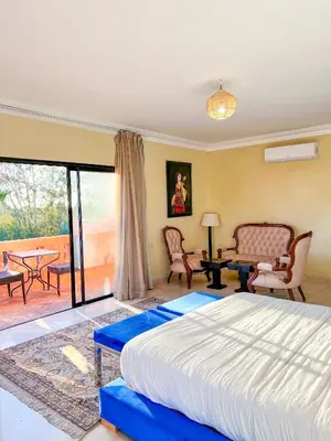 a bedroom with a large bed and a patio at Villa Zeen Garden in Marrakech