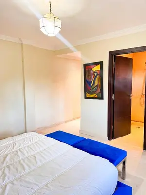 a bedroom with a white bed and a blue rug at Villa Zeen Garden in Marrakech
