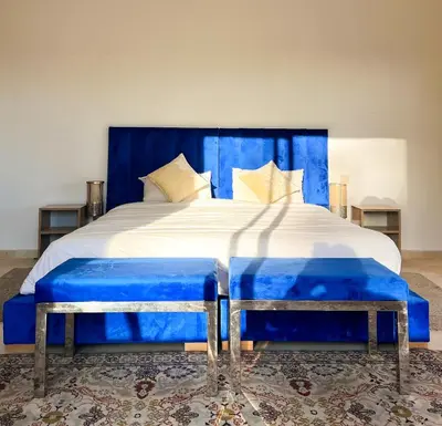 a blue bed with two blue tufted seats on it at Villa Zeen Garden in Marrakech