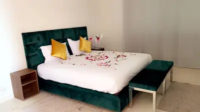 a bedroom with a large bed with flowers on it at Villa Zeen Garden in Marrakech