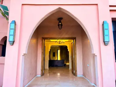 an entrance to a pink building with an archway at Villa Zeen Garden in Marrakech
