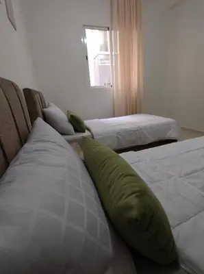 two beds with pillows on them in a room at Diar kamiliya in Meknès