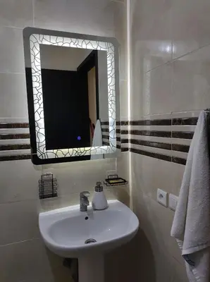 a bathroom with a white sink and a mirror at Diar kamiliya in Meknès
