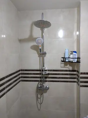 a shower with a shower head in a bathroom at Diar kamiliya in Meknès