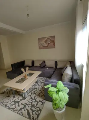 a living room with a couch and a table at Diar kamiliya in Meknès