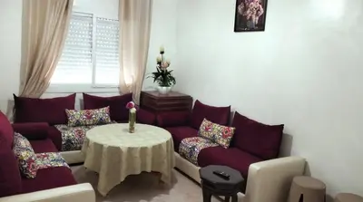 a living room with a couch and a table at Appartement la perle in Fès